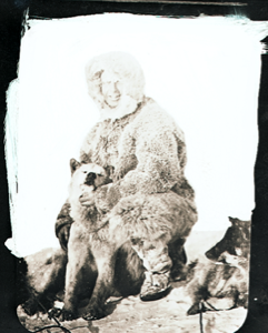 Image of Donald MacMillan kneeling by dog